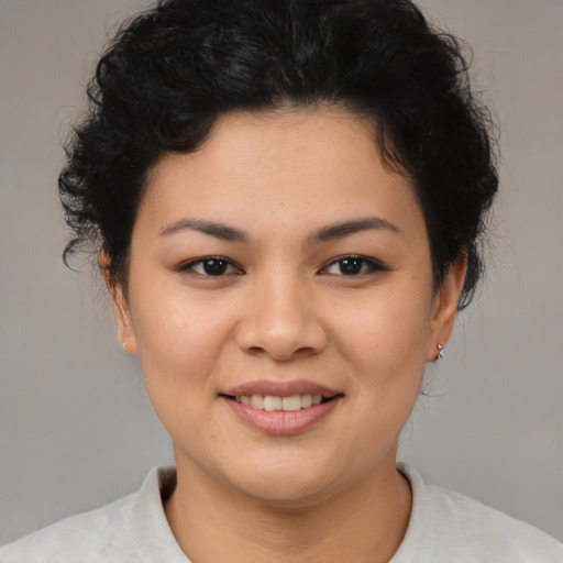 Joyful asian young-adult female with short  brown hair and brown eyes
