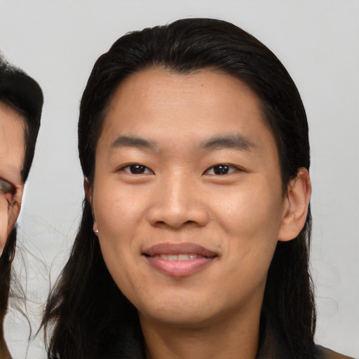 Joyful asian young-adult male with medium  black hair and brown eyes