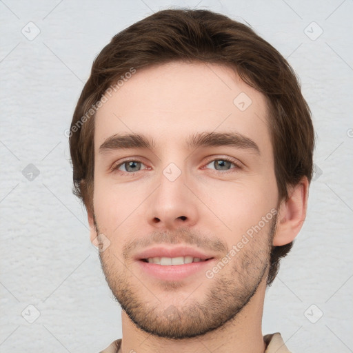 Joyful white young-adult male with short  brown hair and grey eyes