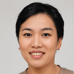 Joyful asian young-adult female with short  black hair and brown eyes