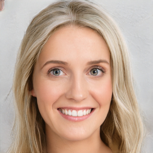 Joyful white young-adult female with long  brown hair and blue eyes