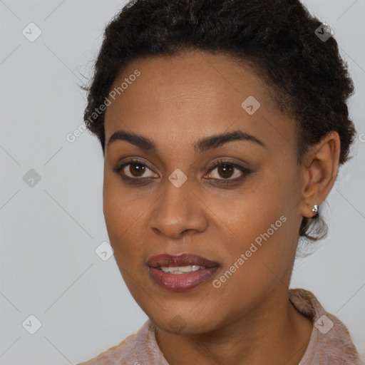 Joyful black young-adult female with short  brown hair and brown eyes