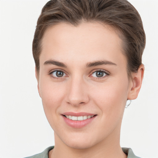 Joyful white young-adult female with short  brown hair and brown eyes