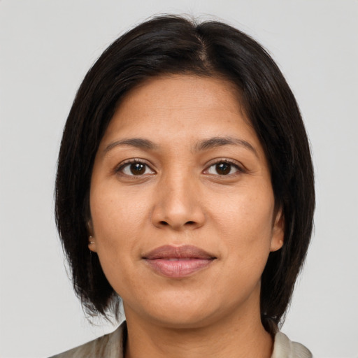Joyful latino young-adult female with medium  brown hair and brown eyes