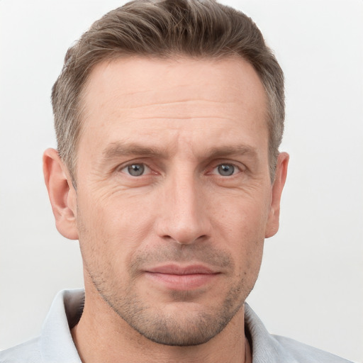 Joyful white adult male with short  brown hair and grey eyes