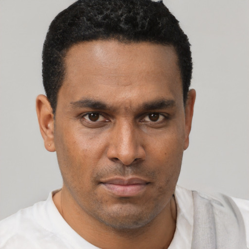 Neutral latino young-adult male with short  black hair and brown eyes