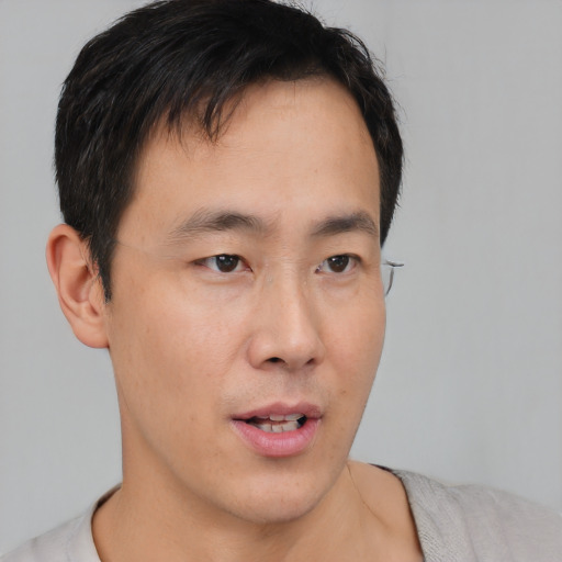 Neutral asian young-adult male with short  brown hair and brown eyes