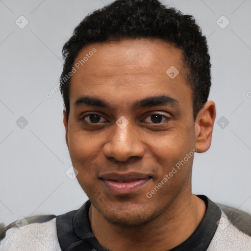 Joyful black young-adult male with short  black hair and brown eyes