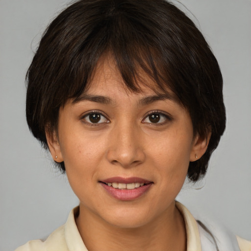 Joyful asian young-adult female with medium  brown hair and brown eyes