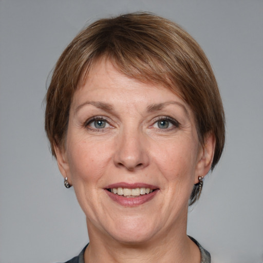 Joyful white adult female with medium  brown hair and grey eyes