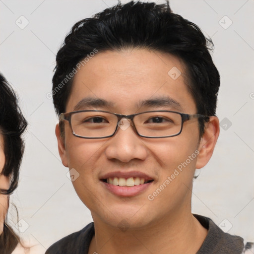 Joyful asian young-adult male with short  black hair and brown eyes