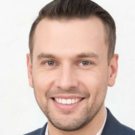 Joyful white young-adult male with short  brown hair and brown eyes