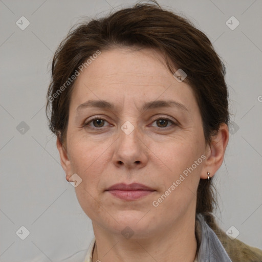 Joyful white adult female with medium  brown hair and grey eyes