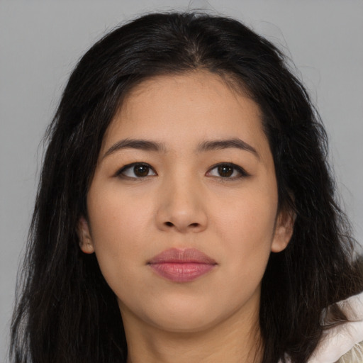 Joyful asian young-adult female with long  brown hair and brown eyes