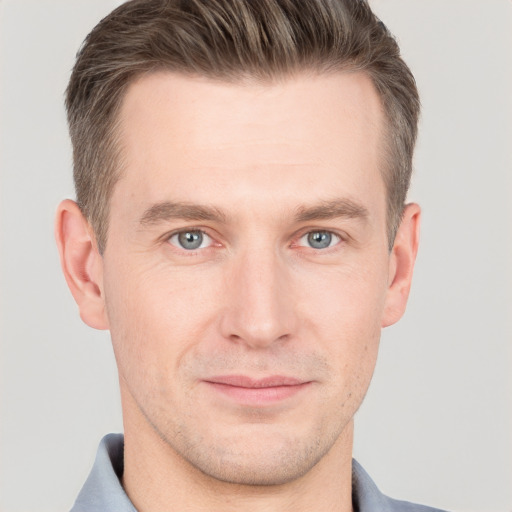 Joyful white adult male with short  brown hair and grey eyes