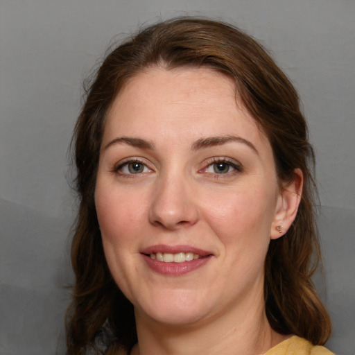 Joyful white young-adult female with medium  brown hair and grey eyes