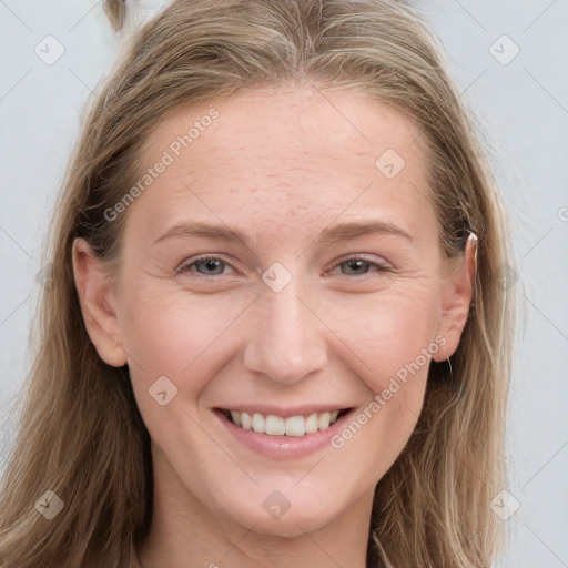 Joyful white young-adult female with long  brown hair and blue eyes