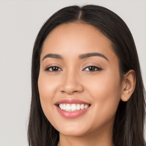 Joyful latino young-adult female with long  black hair and brown eyes