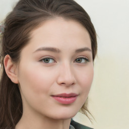 Joyful white young-adult female with long  brown hair and green eyes