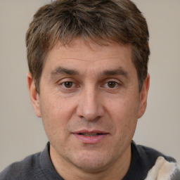 Joyful white adult male with short  brown hair and brown eyes