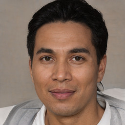 Joyful asian adult male with short  black hair and brown eyes