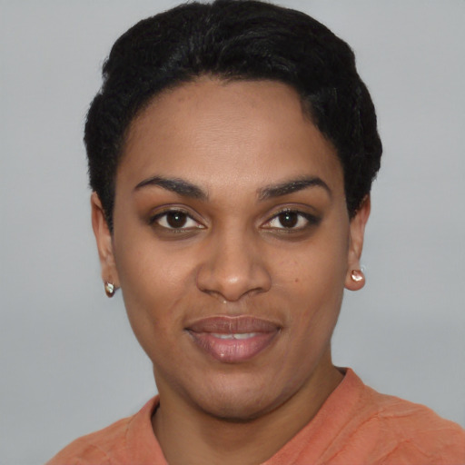 Joyful black young-adult female with short  black hair and brown eyes