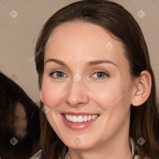 Joyful white young-adult female with long  brown hair and grey eyes