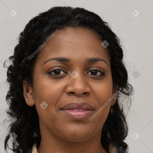 Joyful black young-adult female with long  black hair and brown eyes