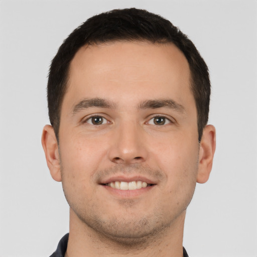 Joyful white young-adult male with short  brown hair and brown eyes