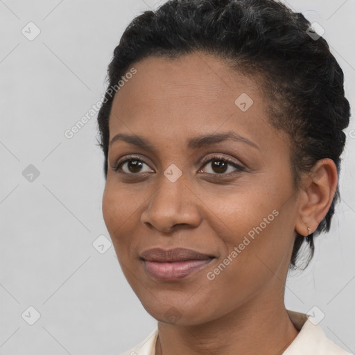 Joyful black young-adult female with short  brown hair and brown eyes