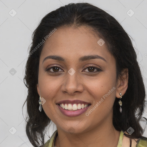 Joyful latino young-adult female with long  brown hair and brown eyes