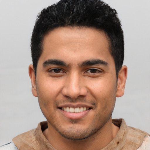 Joyful latino young-adult male with short  brown hair and brown eyes