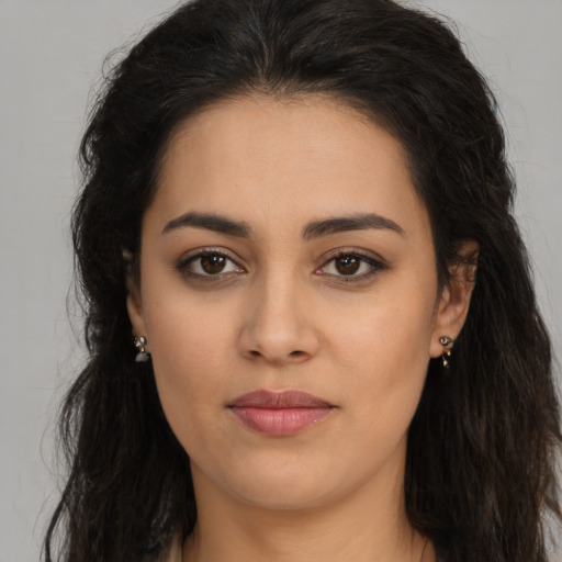 Joyful latino young-adult female with long  brown hair and brown eyes