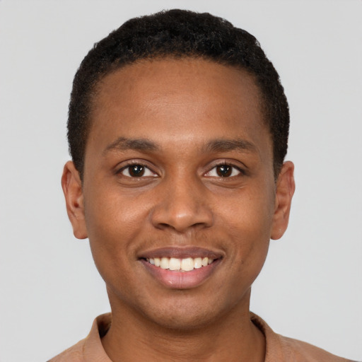 Joyful black young-adult male with short  black hair and brown eyes