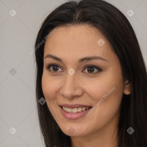 Joyful latino young-adult female with long  brown hair and brown eyes