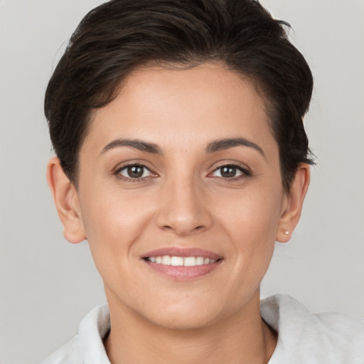 Joyful white young-adult female with short  brown hair and brown eyes