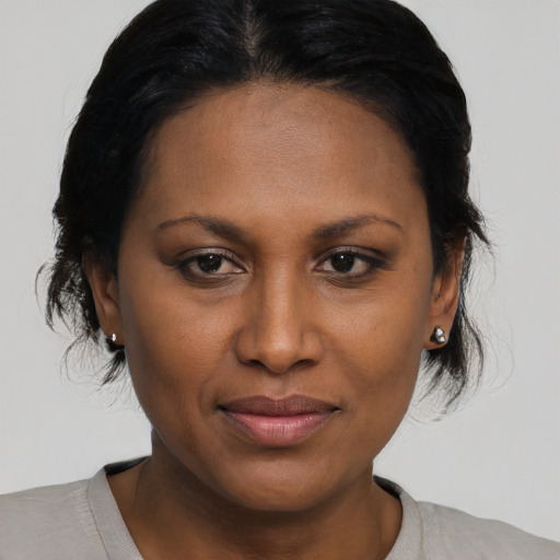Joyful black young-adult female with medium  brown hair and brown eyes