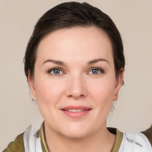 Joyful white young-adult female with medium  brown hair and grey eyes