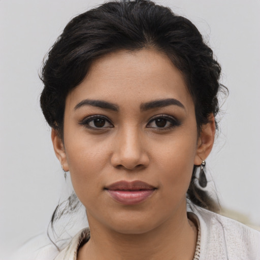 Joyful latino young-adult female with short  brown hair and brown eyes