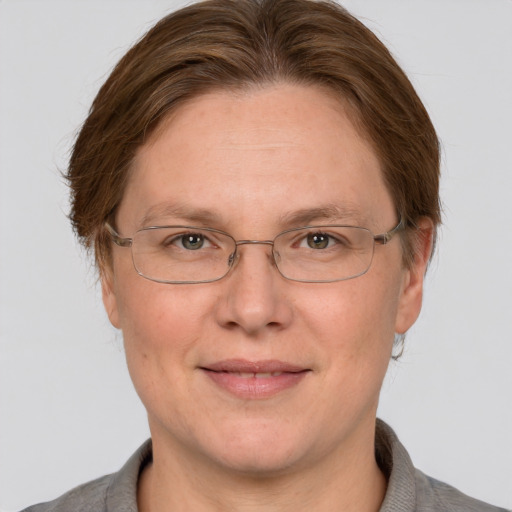 Joyful white adult female with short  brown hair and grey eyes