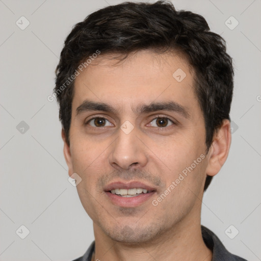 Joyful white young-adult male with short  black hair and brown eyes