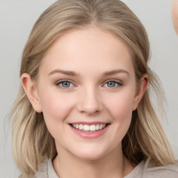 Joyful white young-adult female with medium  brown hair and blue eyes