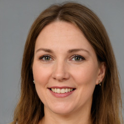 Joyful white adult female with long  brown hair and brown eyes