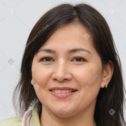 Joyful white adult female with long  brown hair and brown eyes