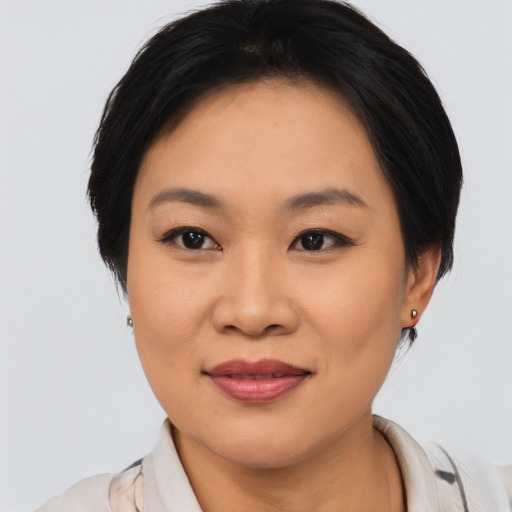 Joyful asian young-adult female with medium  black hair and brown eyes