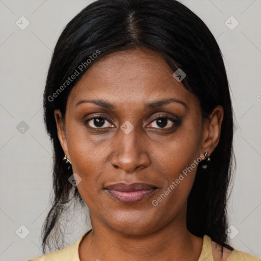 Joyful black adult female with medium  brown hair and brown eyes