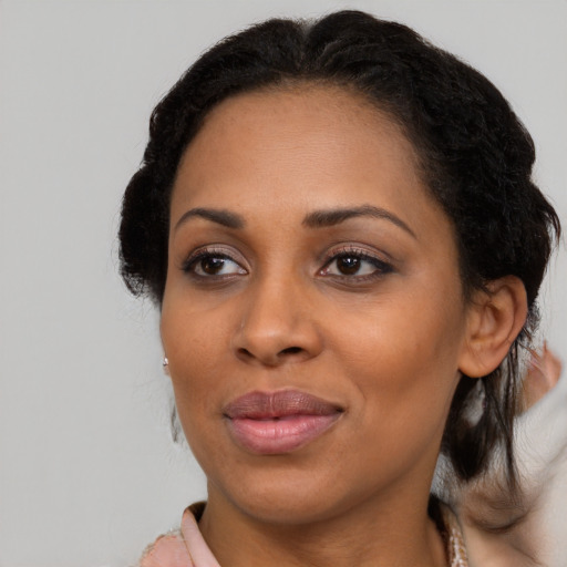 Joyful black adult female with medium  black hair and brown eyes