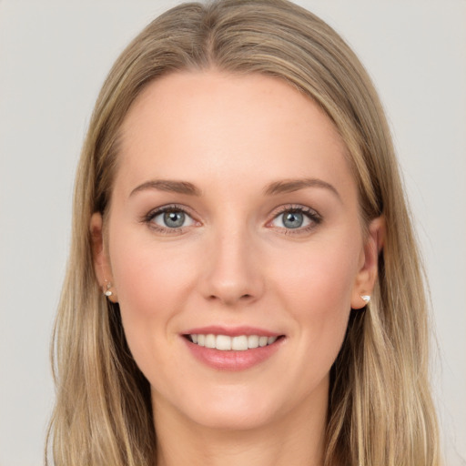 Joyful white young-adult female with long  brown hair and blue eyes