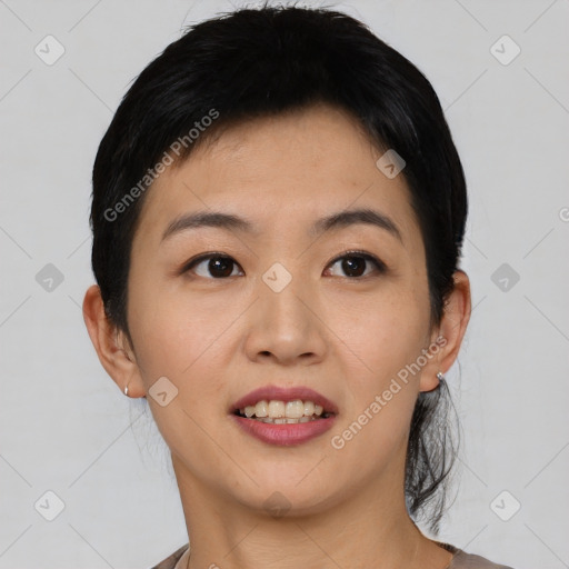 Joyful asian young-adult female with short  black hair and brown eyes