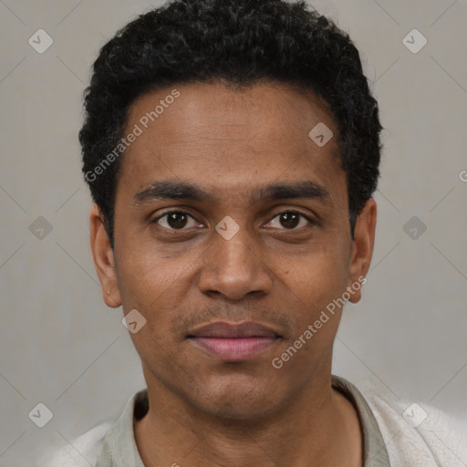 Joyful black young-adult male with short  black hair and brown eyes